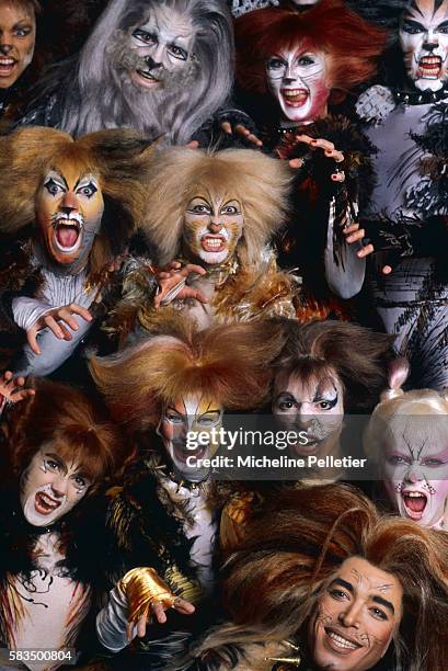 Sea of fanciful feline faces belonging to members of the cast of the musical Cats bare their teeth during the play's Paris season at the Theatre de...