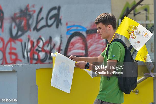 Young man is selling gadgets and souvenirs from the World Youth Day 2016 on a tramway stop near the Jean Paul II National Shrine in...