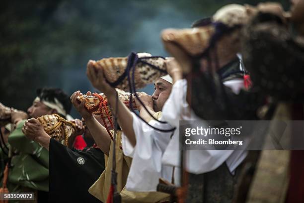 Conch blowers mark the end of the Generals' Meeting during the Soma Nomaoi festival in Minamisoma, Fukushima Prefecture, Japan, on Saturday, July 23,...
