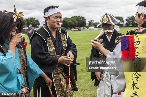 Samurai horsemen chat after a procession at Hibarigahara field during the Soma Nomaoi festival in Minamisoma, Fukushima Prefecture, Japan, on...