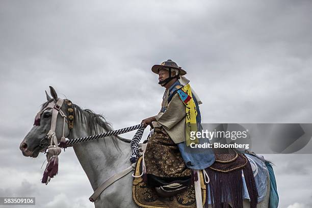Samurai horseman makes his way through Hibarigahara field during the Soma Nomaoi festival in Minamisoma, Fukushima Prefecture, Japan, on Saturday,...