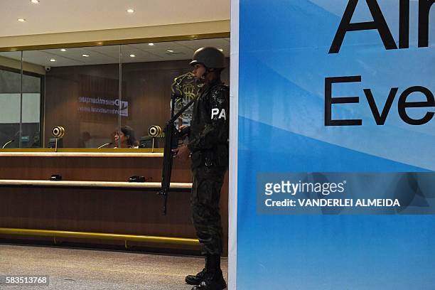 Brazilian Air Force personnel guard at the Galeao International airport in Rio de Janeiro, Brazil, on July 26, 2016. / AFP / VANDERLEI ALMEIDA