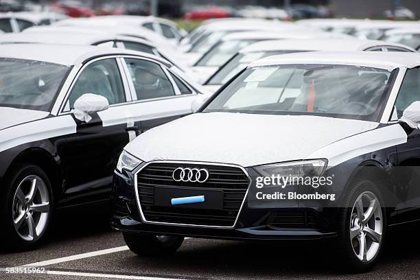 Completed Audi A3 automobiles with protective coverings stand parked outside the Audi AG production plant in Gyor, Hungary, on Monday, July 25, 2016....