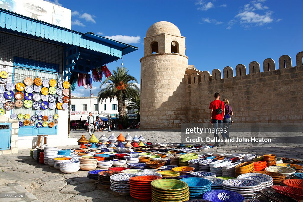 Africa, Tunisia, Sousse, Medina, Place de la Grande Mosque, Pottery Shop display outside Great Mosque, Couple
