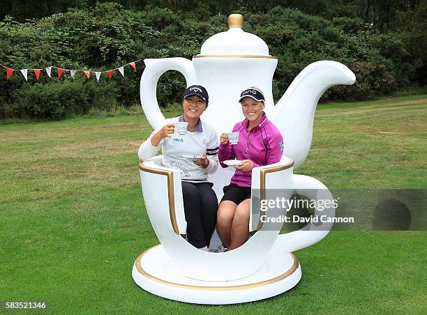 Lydia Ko of New Zealand and Brooke Henderson of Canada attend a traditional English tea party hosted by Charley Hull of England at a photocall during...