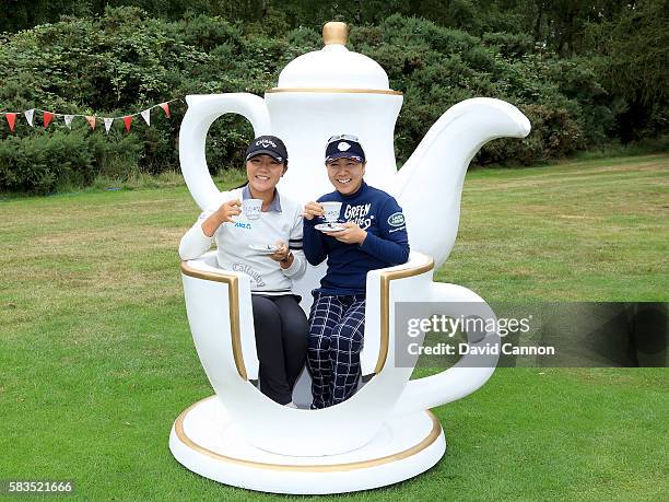 Lydia Ko of New Zealand and Mika Miyazato of Japan, attend a traditional English tea party hosted by Charley Hull of England at a photocall during a...