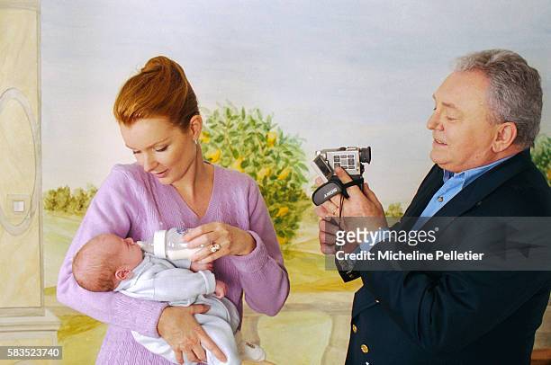 French television personality Jacques Martin videotaping his wife Celine holding their one-month-old infant Clovis. Jacques Martin is a television...
