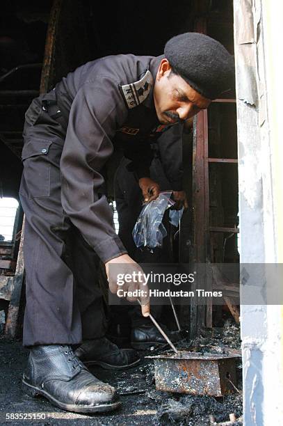 Forensic experts collecting the evidence from the boggies of Delhi- Atari train which caught fire after the blast at Diwana in Panipat. Samjhauta...