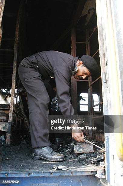 Forensic experts collecting the evidence from the boggies of Delhi- Atari train which caught fire after the blast at Diwana in Panipat. The 2007...