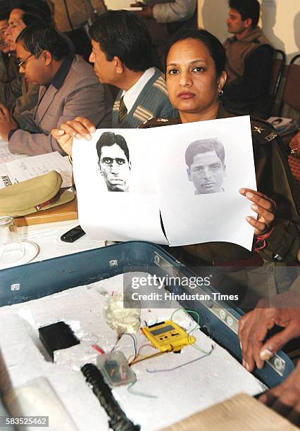 Haryana police officer showing the sketchEs of two suspects who are involved in Delhi Atari express blast and the improvise explosive device used as...