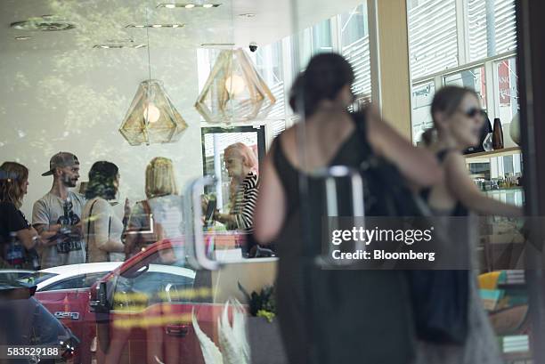 Shoppers enter a store on South Congress Avenue in Austin, Texas, U.S., on Saturday, July 23, 2016. Consumer confidence was little changed in July as...