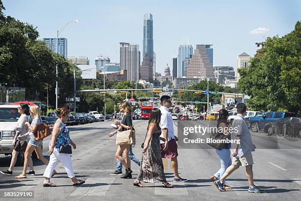 Pedestrians cross South Congress Avenue with the downtown skyline seen in the background in Austin, Texas, U.S., on Saturday, July 23, 2016. Consumer...