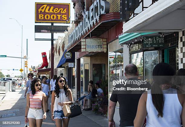 Pedestrians walk past stores on South Congress Avenue in Austin, Texas, U.S., on Saturday, July 23, 2016. Consumer confidence was little changed in...