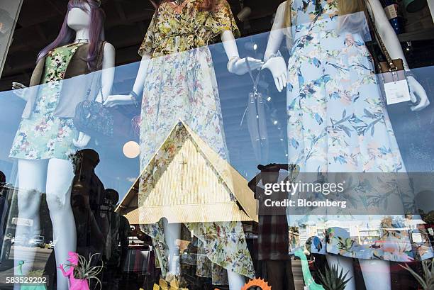 Pedestrians are reflected on a store window display on South Congress Avenue in Austin, Texas, U.S., on Saturday, July 23, 2016. Consumer confidence...