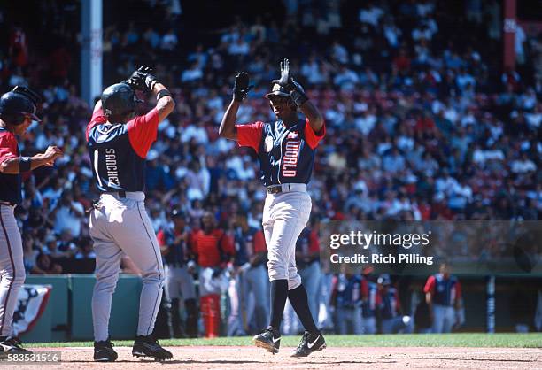 Alfonso Soriano of the World Team is greeted at home plate after hitting a three-run home run during the Futures Game at Fenway Park on Sunday, July...