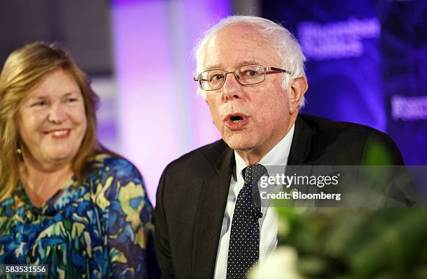Senator Bernie Sanders, an independent from Vermont, speaks as his wife Jane Sanders smiles during a Bloomberg Politics interview on the sidelines of...