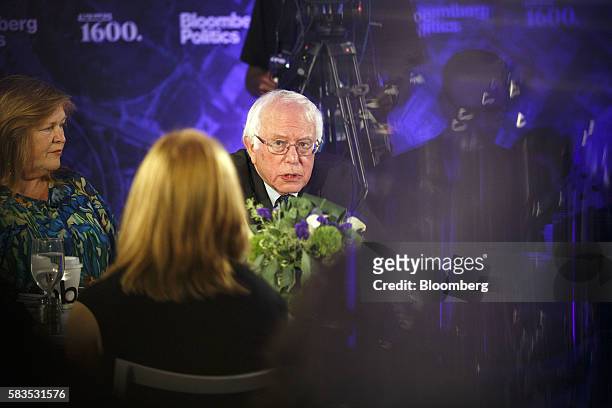 Senator Bernie Sanders, an independent from Vermont, center, speaks as his wife Jane Sanders listens during a Bloomberg Politics interview on the...