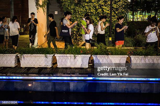 People play the Pokemon Go game at a park at Tin Shui Wai on July 26, 2016 in Hong Kong. "Pokemon Go," which has been a smash-hit across the globe...
