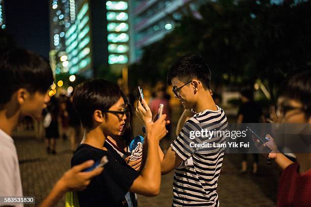 People play the Pokemon Go game at a park at Tin Shui Wai on July 26, 2016 in Hong Kong. "Pokemon Go," which has been a smash-hit across the globe...