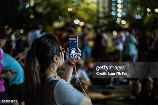 People play the Pokemon Go game at a park at Tin Shui Wai on July 26, 2016 in Hong Kong. "Pokemon Go," which has been a smash-hit across the globe...