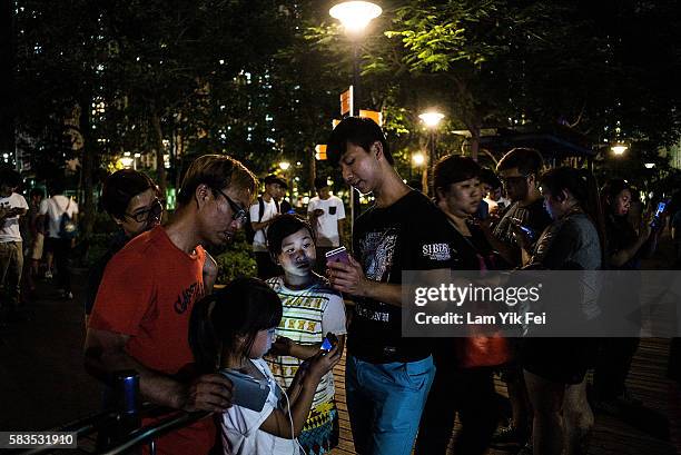 People play the Pokemon Go game at a park at Tin Shui Wai on July 26, 2016 in Hong Kong. "Pokemon Go," which has been a smash-hit across the globe...