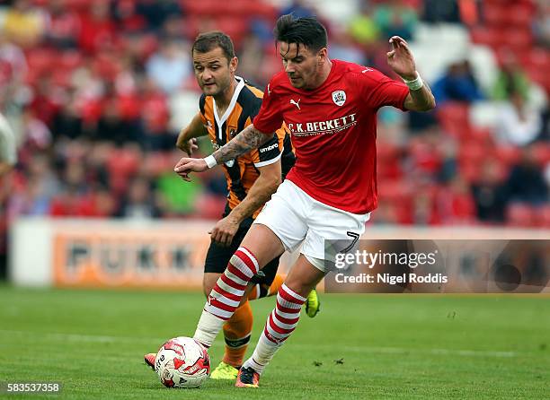 Adam Hammill of Barnsley challenged by Shaun Maloney of Hull City during the Pre-Season Friendly match between Barnsley and Hull City at Oakwell...