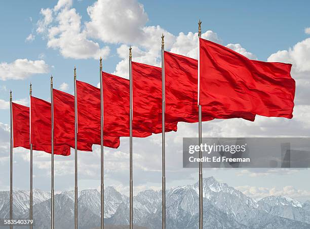 red flags, mountains in distance - red ensign stock pictures, royalty-free photos & images