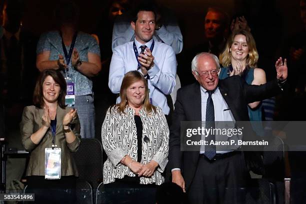 Sen. Bernie Sanders waves to the crowd as his wife Jane O'Meara Sanders looks on during the second day of the Democratic National Convention at the...