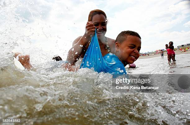Boy swims at Rockaway Beach on July 26, 2016 in New York City. A heat wave continues with temperatures expected to stay in the 90's across most of...