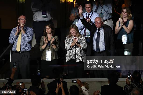 Sen. Bernie Sanders waves to the crowd as his wife Jane O'Meara Sanders looks on during the second day of the Democratic National Convention at the...