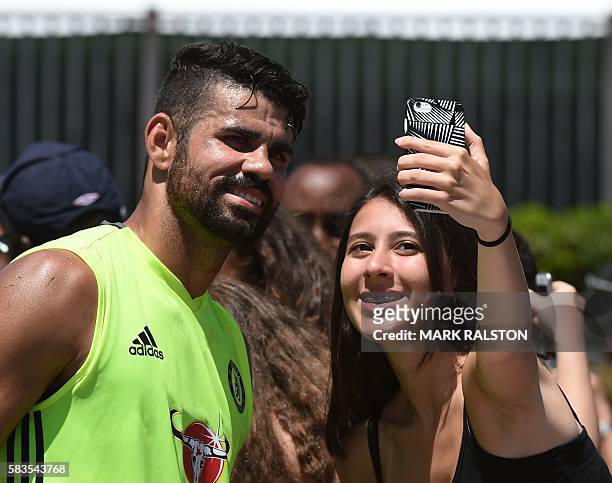 Chelsea striker Diego Costa poses with a fan before their International Champions Cup game against Liverpool, at the UCLA Campus in Westwood,...