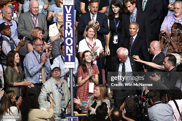 Sen. Bernie Sanders , along with his wife Jane O'Meara Sanders , arrive on the floor during roll call on the second day of the Democratic National...