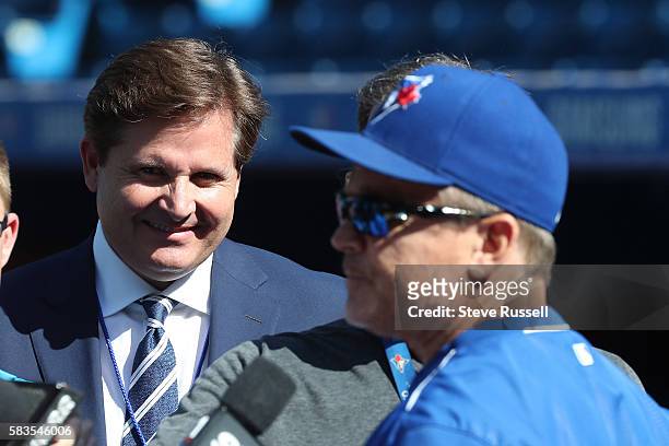 Broadcaster Matt Devlin watches over a Toronto Blue Jays manager John Gibbons scrum as the Toronto Blue Jays play the San Diego Padres at the Rogers...