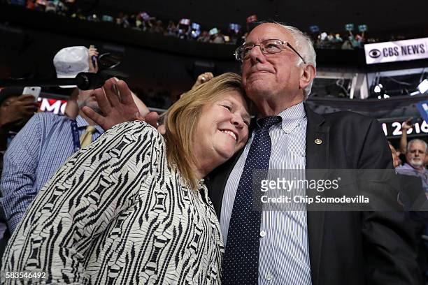 Sen. Bernie Sanders embraces his wife Jane O'Meara Sanders after the Vermont delegation cast their votes during roll call on the second day of the...
