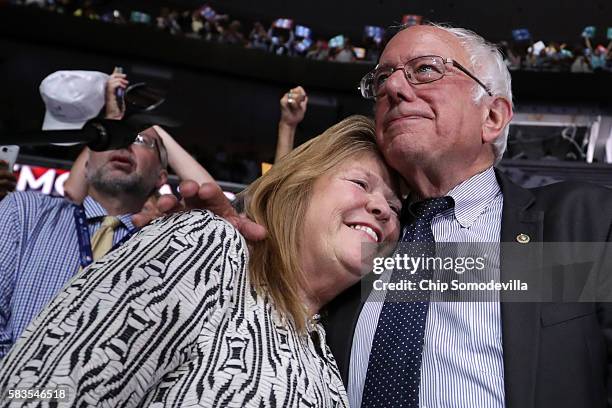 Sen. Bernie Sanders embraces his wife Jane O'Meara Sanders after the Vermont delegation cast their votes during roll call on the second day of the...