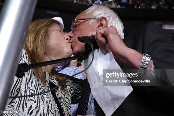 Sen. Bernie Sanders kisses his wife Jane O'Meara Sanders after the Vermont delegation cast their votes during roll call on the second day of the...