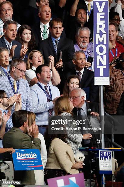 Sen. Bernie Sanders kisses his wife Jane O'Meara Sanders after the Vermont delegation cast their votes during roll call on the second day of the...