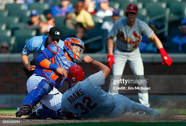 Rene Rivera of the New York Mets tags out Matt Adams of the St. Louis Cardinals at home to end the fifth inning at Citi Field on July 26, 2016 in the...