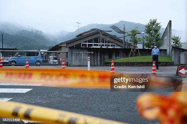 Police officer stands guard in front of Tsukui Yamayuri En care home on July 27, 2016 in Sagamihara, Japan. A man who claimed he wanted to kill...