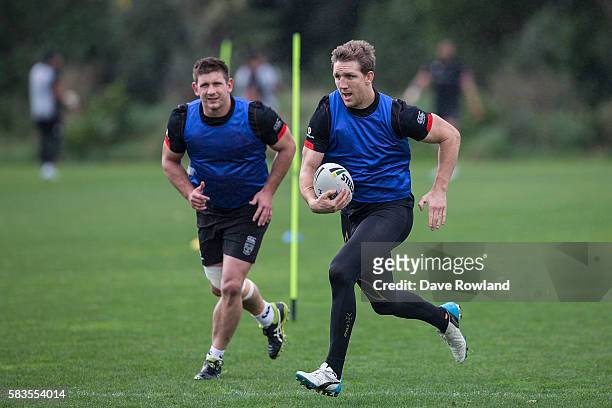 Jacob Lillyman, chases Captain Ryan Hoffman during a New Zealand Warriors NRL training session at Mt Smart Stadium on July 27, 2016 in Auckland, New...