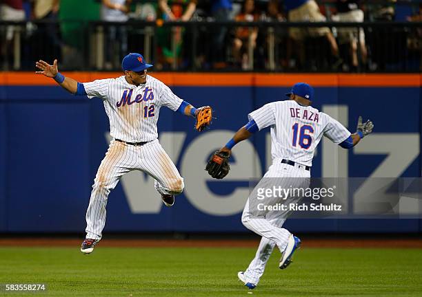 Juan Lagares and Alejandro De Aza of the New York Mets celebrate after defeating the St. Louis Cardinals 3-1 during game two of a doubleheader at...