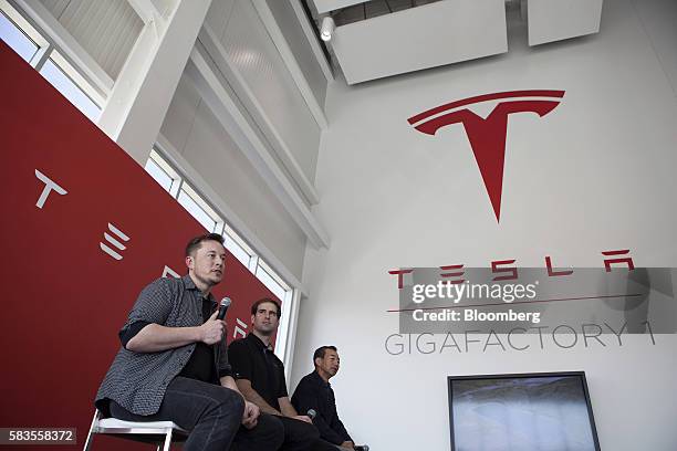 Billionaire Elon Musk, chief executive officer of Tesla Motors Inc., left, speaks as Jeffrey Straubel, chief technical officer and co-founder of...