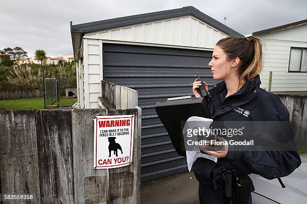 Animal Management Officer Kelsey at a Ranui property on July 27, 2016 in Auckland, New Zealand. The Auckland Council Animal Control undertook a...