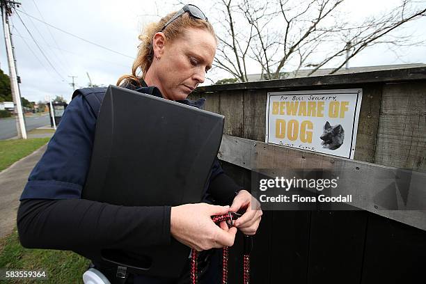 Animal Management Officer Kirsten prepares to remove a Pitbull from a Swanson property on July 27, 2016 in Auckland, New Zealand. The Auckland...