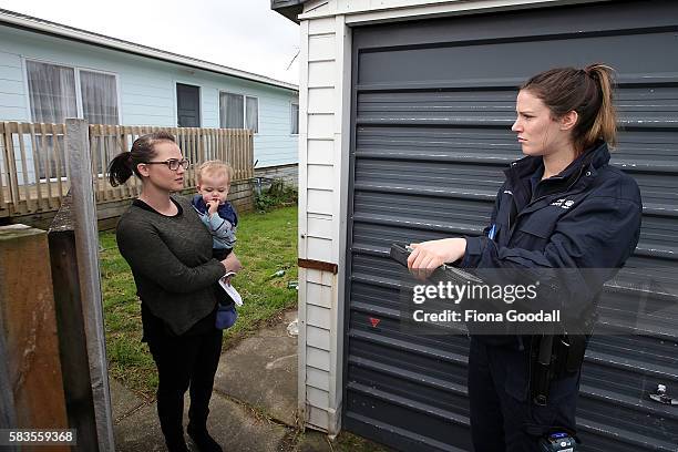 Animal Management Officer Kelsey speaks to a resident at a Ranui property on July 27, 2016 in Auckland, New Zealand. The Auckland Council Animal...