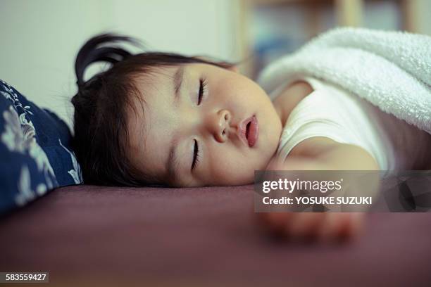 sleeping an asian baby - portrait candid ストックフォトと画像