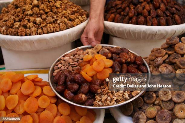 fruit and nuts for sale in a souk in morocco - fruta seca fotografías e imágenes de stock