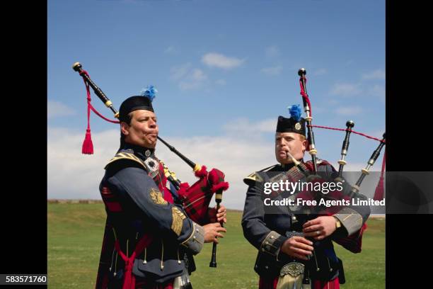 bagpipers playing bagpipes - bagpipes stock pictures, royalty-free photos & images