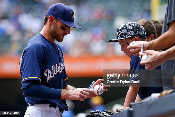 Will Middlebrooks of the Milwaukee Brewers signs autographs for fans before the game against the Chicago Cubs at Miller Park on July 24, 2016 in...