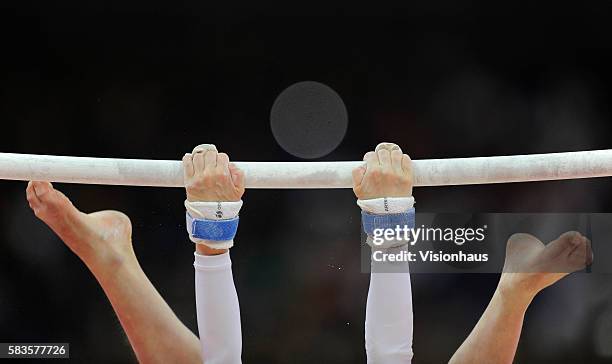 Close up detail of a gymnast's hands and feet on the uneven bars during the Womens Artistic Gymnastics Qualification as part of the 2012 London...